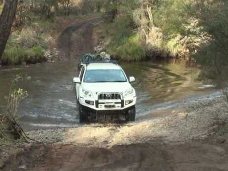 Volare Costa Rica 4x4 crosses stream in dirt road